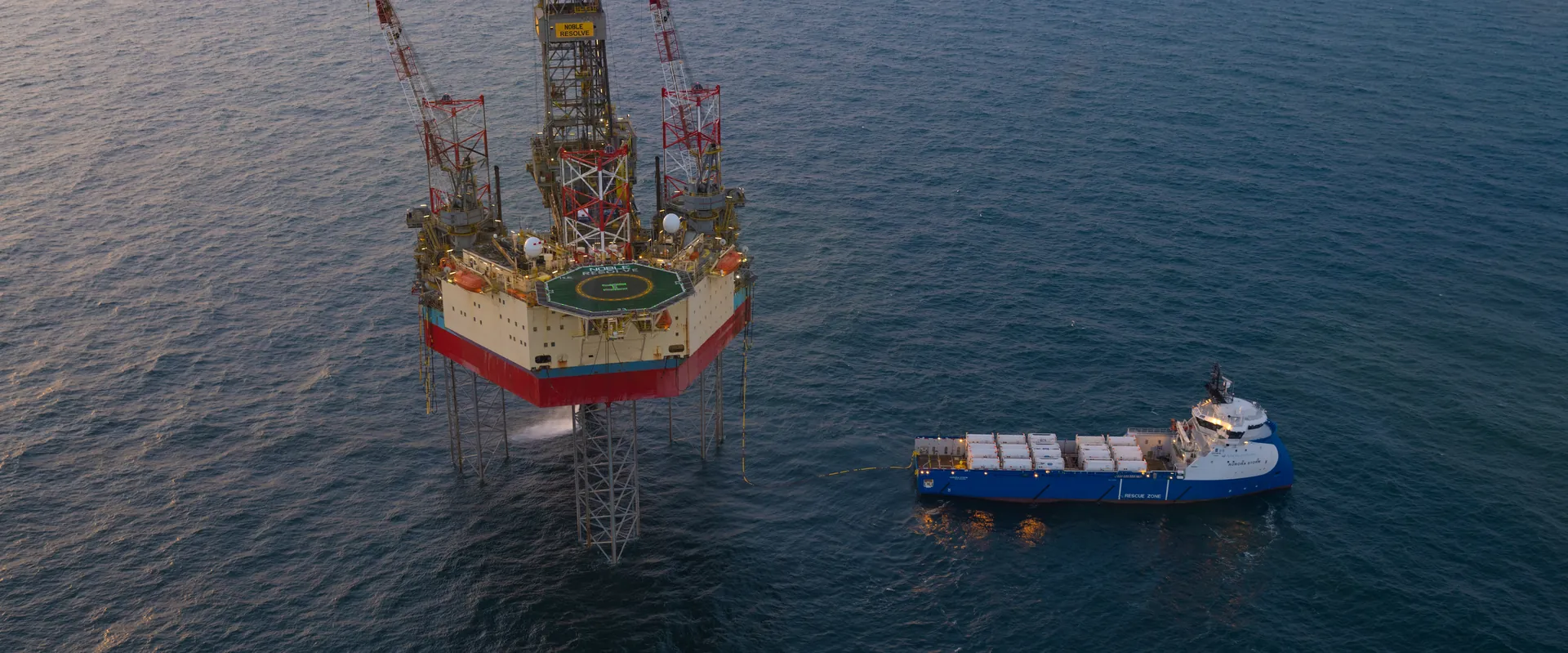 Offshore platform and supply vessel loaded with Bofort liquid CO2 ISO tanks in the North Sea